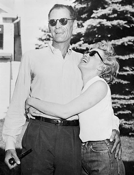 Marilyn Monroe hugs Arthur Miller at the playwright`s 20-acre summer home here, June 25th. The wedding date is still indefinite.