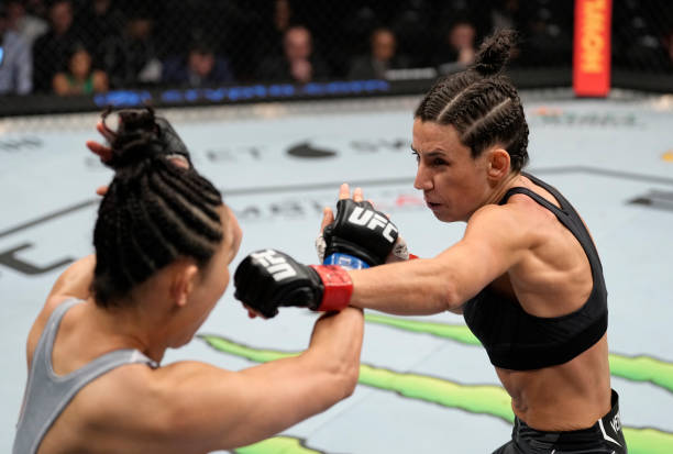 Marina Rodriguez of Brazil punches Yan Xiaonan of China in their strawweight fight during the UFC 272 event on March 05, 2022 in Las Vegas, Nevada.