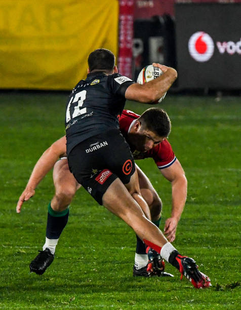 JOHANNESBURG, SOUTH AFRICA - JULY 07: Marius Louw of the Sharks challenged by Owen Farrel of the British and Irish Lions during the Tour match between Cell C Sharks and British and Irish Lions at Emirates Airline Park on July 07, 2021 in Johannesburg, South Africa. (Photo by Sydney Seshibedi/Gallo Images/Getty Images)
