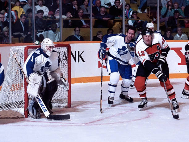 Mark Laforest and Brad Marsh of the Toronto Maple Leafs skate against Tim Kerr of the Philadelphia Flyers during NHL game action November 4 at Maple...