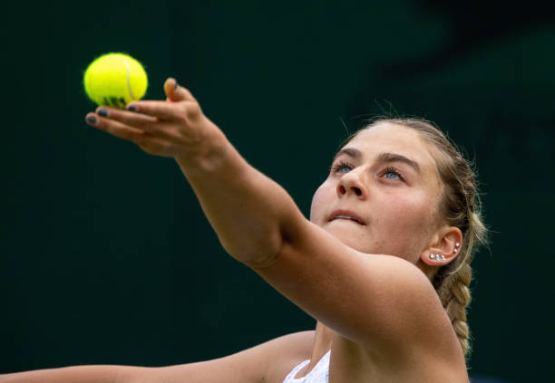 Marta Kostyuk of Ukraine serves in her Ladies' Singles First Round match against Kiki Bertens of The Netherlands during Day Two of The Championships...