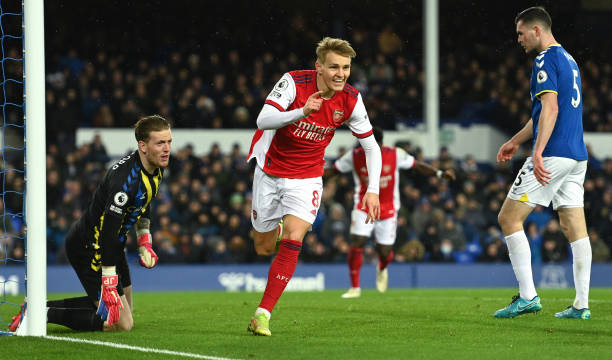 Martin Odegaard of Arsenal celebrates after scoring their side's first goal as Jordan Pickford of Everton looks dejected during the Premier League...