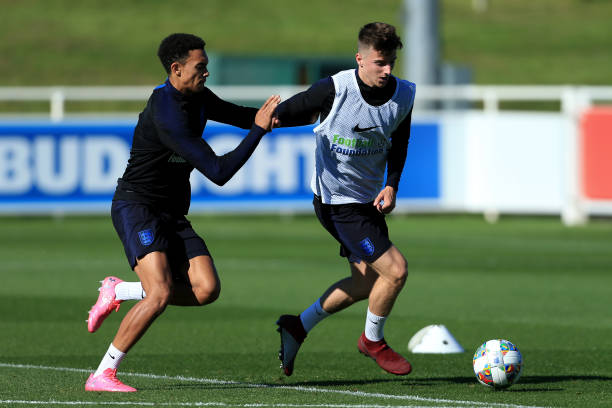 Mason Mount battles with Trent Alexander-Arnold during an England training session at St. George's Park on October 9, 2018 in Burton-upon-Trent,...