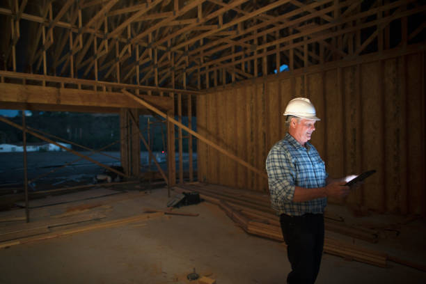mature man using a digital tablet at a construction site - construction wifi stock pictures, royalty-free photos & images