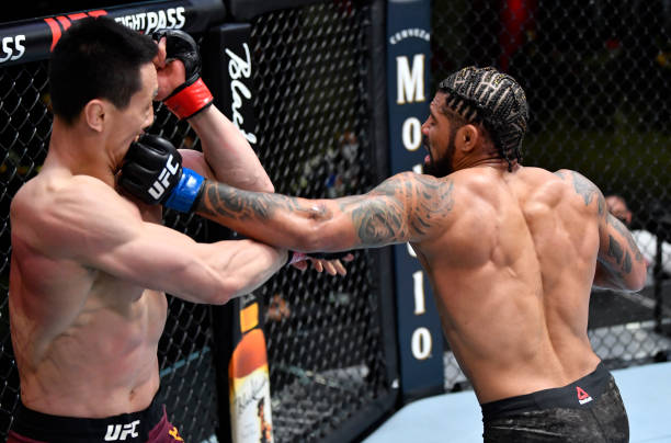 Max Griffin punches Song Kenan of China in their welterweight fight during the UFC Fight Night event at UFC APEX on March 20, 2021 in Las Vegas,...