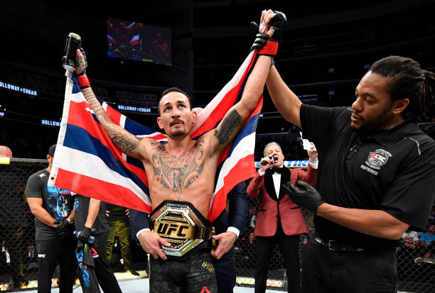 Max Holloway celebrates after defeating Frankie Edgar in their UFC featherweight championship bout during the UFC 240 event at Rogers Place on July...