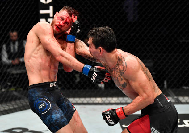 Max Holloway punches Calvin Kattar in a featherweight bout during the UFC Fight Night event at Etihad Arena on UFC Fight Island on January 17, 2021...
