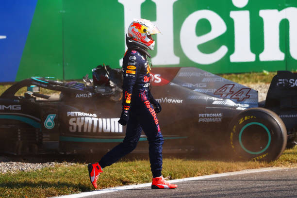 Max Verstappen of the Netherlands and Red Bull Racing walks past the Lewis Hamilton of Great Britain and Mercedes AMG Petronas after they collided at...