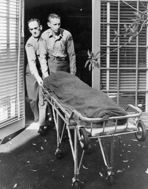 Medical attendents removing the body of Marilyn Monroe from her home.