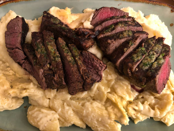 medium rare steak on mashed potatoes picture