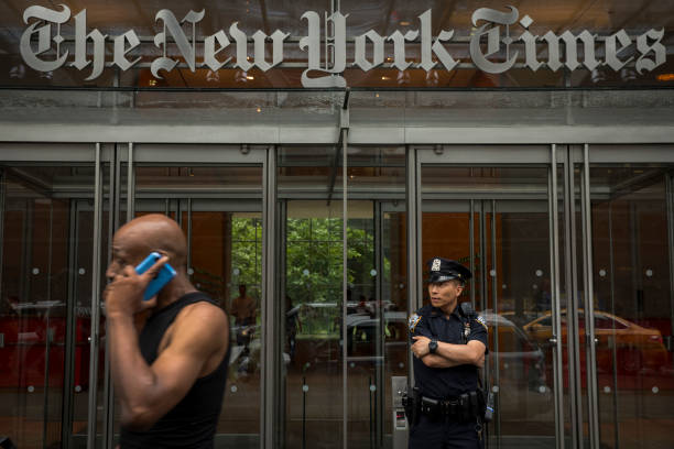 Member of the New York City Police Department stands outside the headquarters of The New York Times, June 28, 2018 in New York City. NYPD announced...