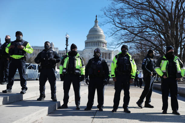Members of the Metropolitan Police Department of the District of Columbia are seen in front of the U.S. Capitol a day after a pro-Trump mob broke...
