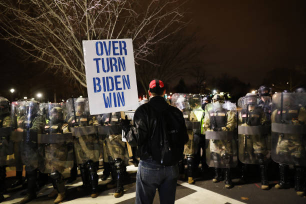 Members of the National Guard and the Washington D.C. Police keep a small group of demonstrators away from the Capital after thousands of Donald...