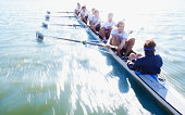 Men in row boat oaring