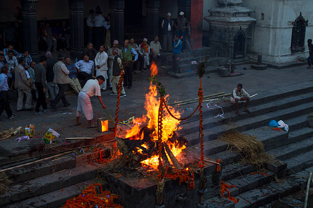 men watching cremation fire at pashupatinath - hindu funeral stock pictures, royalty-free photos & images
