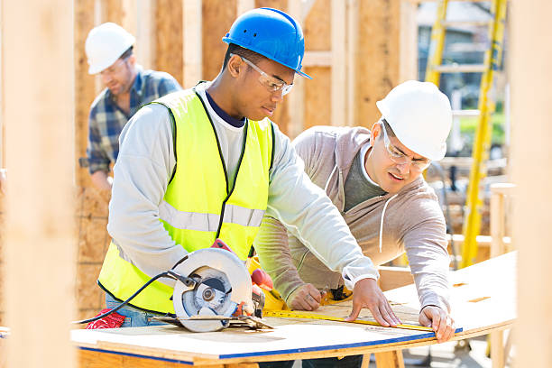 men work together at construction site - construction stock pictures, royalty-free photos & images