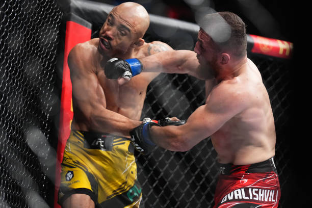 Merab Dvalishvili of Georgia punches Jose Aldo of Brazil in a bantamweight fight during the UFC 278 event at Vivint Arena on August 20, 2022 in Salt...