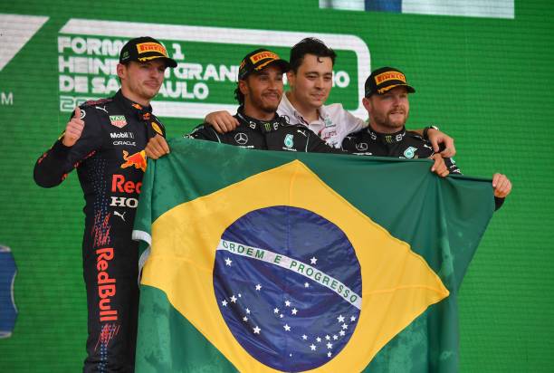Mercedes' British driver Lewis Hamilton , Red Bull's Dutch driver Max Verstappen and Mercedes' Finnish driver Valtteri Bottas celebrate with Mercedes...