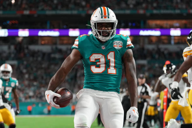Miami Dolphins running back Raheem Mostert flexes after his touchdown during the game between the Pittsburg Steelers and the Miami Dolphins on...