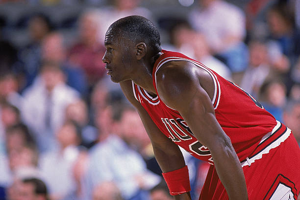 Michael Jordan of the Chicago Bulls rests on the court during a game. NOTE TO USER: User expressly acknowledges and agrees that, by downloading...