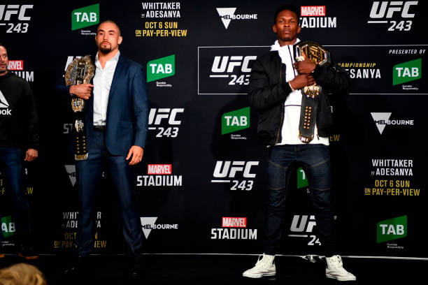 Middleweight champion Robert Whittaker of New Zealand and UFC interim middleweight champion Israel Adesanya of New Zealand pose for the media during...