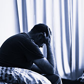 Mid-life crisis: depressed mature man, head in hands