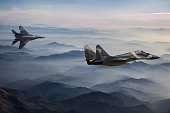 Mig-29 Fighter Jets in Flight above the fogy mountains