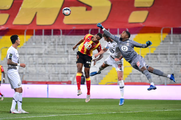 Mike Maignan of Lille OSC boxes the ball during the Ligue 1 match between RC Lens and Lille OSC at Stade Bollaert-Delelis on May 07, 2021 in Lens,...