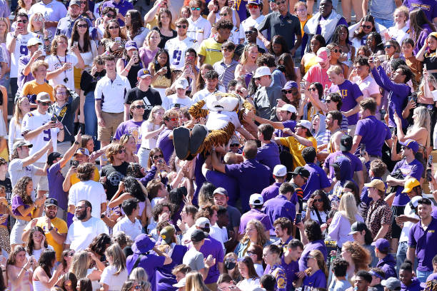 Mike the Tiger of LSU Tigers is carried by fans during the second half against the Florida Gators at Tiger Stadium on October 16, 2021 in Baton...
