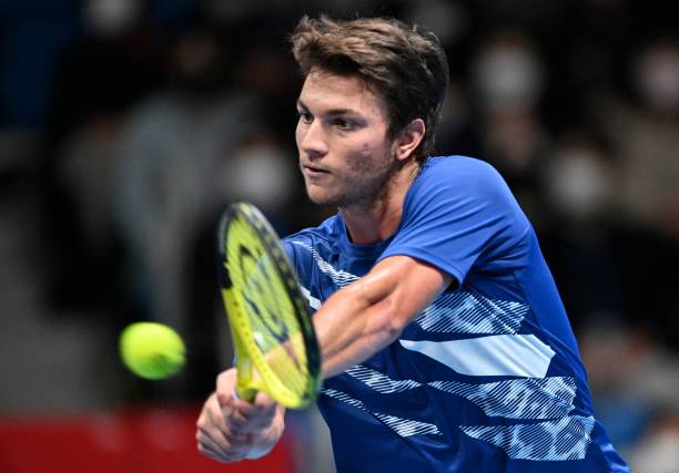 Miomir Kecmanovic of Serbia hits a return against Frances Tiafoe of the US during their men's singles quarter-final match at the Japan Open tennis...