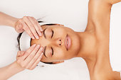 Mixed-Race Woman Enjoying Face Massage in Spa