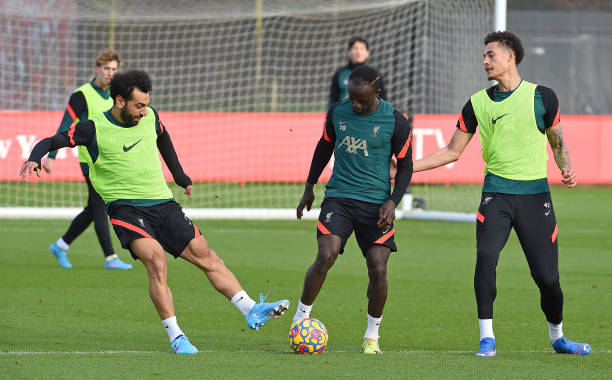 Mohamed Salah of Liverpool with Sadio Mane of Liverpool during a training session at AXA Training Centre on February 11, 2022 in Kirkby, England.