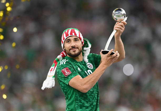 Mohammed Belaili of Algeria receives the Adidas Silver Ball award following the FIFA Arab Cup Qatar 2021 Final match between Tunisia and Algeria at...