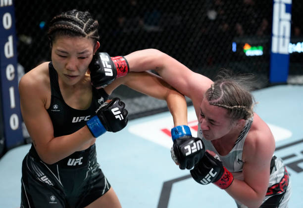 Molly McCann of England punches Ji Yeon Kim of South Korea in their flyweight fight during the UFC Fight Night event at UFC APEX on September 04,...