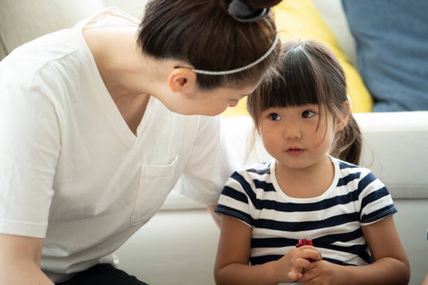 mother and daughter are looking at each other - asian mother and little daughter stock pictures, royalty-free photos & images