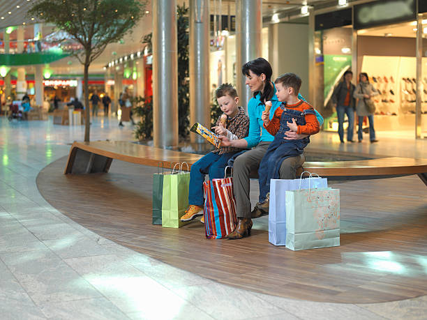mother sitting with two sons in shopping centre picture id200440786 001?k=20&m=200440786