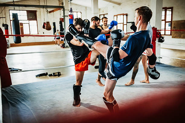 Muay thai boxing athletes training in boxing ring