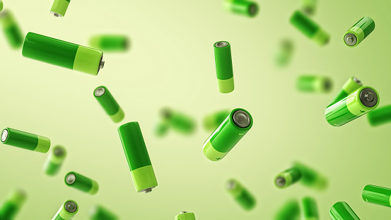Multiple falling green batteries with depth of field. Green energy concept.