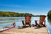 Muskoka chairs on a wooden dock