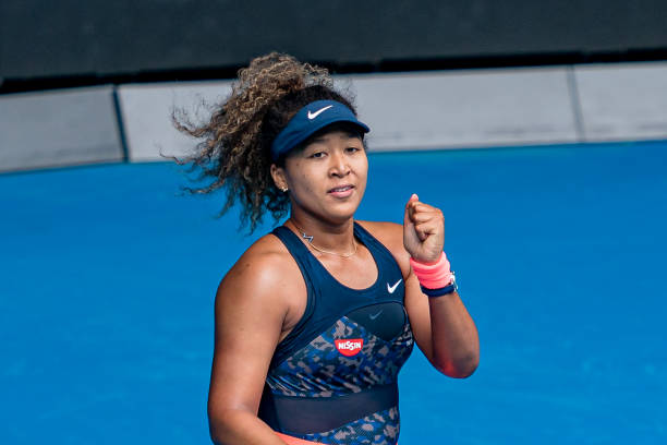 Naomi Osaka of Japan celebrates after winning match point in her Women's Singles fourth round match against Garbine Muguruza of Spain during day...