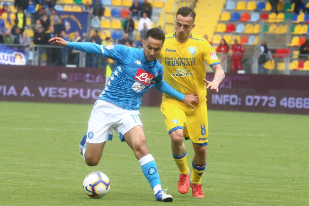 Napoli's French forward Adam Ounas (L) fights for the ball...