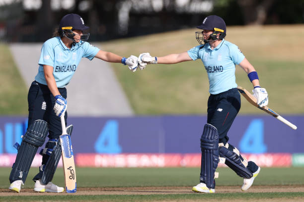 England vs India - Natalie Sciver and Heather Knight of England bump fists during the 2022 ICC Women's Cricket World Cup match between England and India at Bay Oval on...