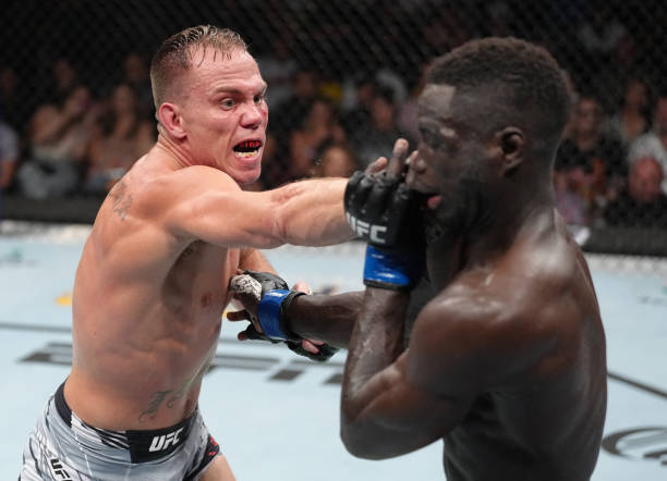 Nate Landwehr punches David Onama of Uganda in a featherweight fight during the UFC Fight Night event at Pechanga Arena on August 13, 2022 in San...