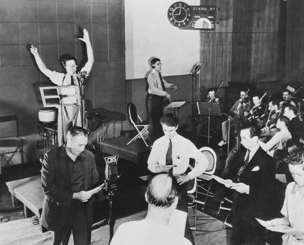 New York, Orson WELLES rehearsing one of his radio programs on CBS. During one of those, he read Herbert George WELLS's book, WAR OF THE WORLDS. The...