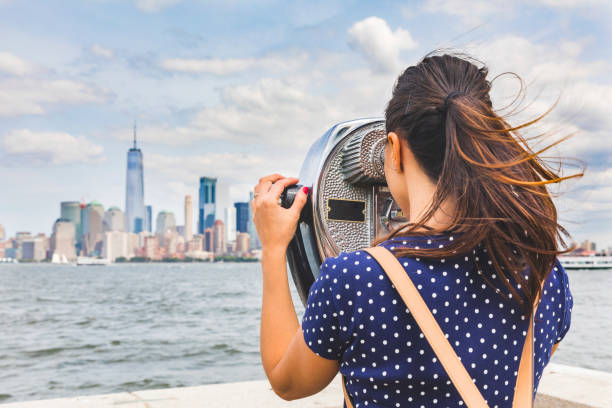 new york woman looking at manhattan skyline with coinoperated picture