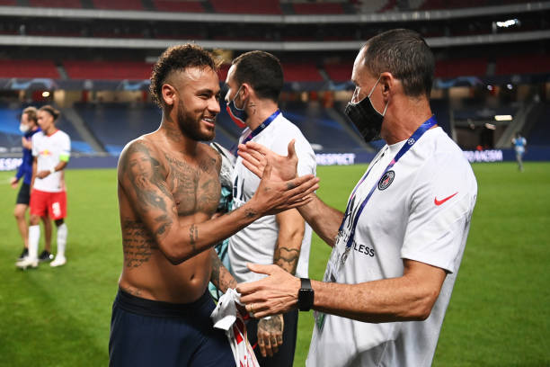 Neymar of Paris SaintGermain celebrates victory with a member of the PSG backroom staff after the UEFA Champions League Semi Final match between RB...
