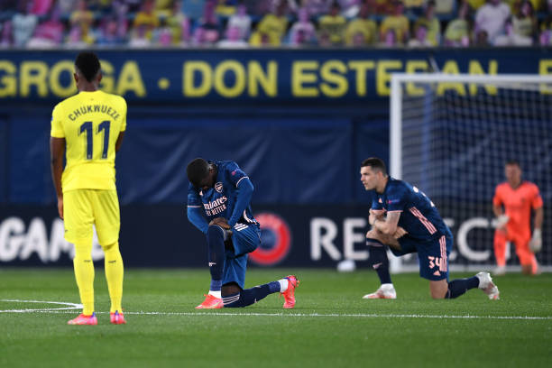 Nicolas Pepe of Arsenal takes a knee in support of the Black Lives Matter movement prior to the UEFA Europa League Semi-final First Leg match between...