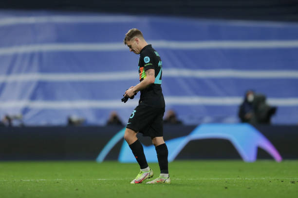 Nicolo Barella FC Internazionale Milano leaves the pitch after receiving a red card during the UEFA Champions League group D match between Real...