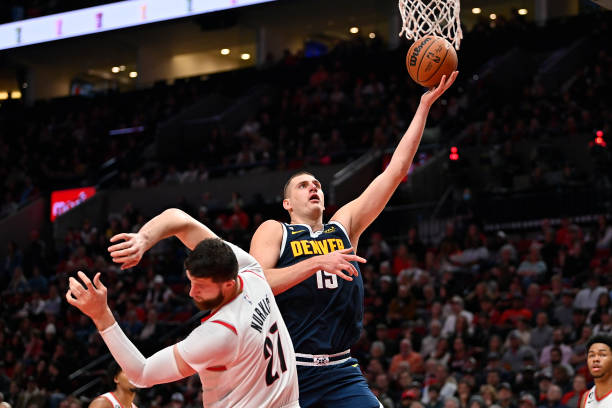 Nikola Jokic of the Denver Nuggets drives against Jusuf Nurkic of the Portland Trail Blazers during the fourth quarter at Moda Center on October 24,...