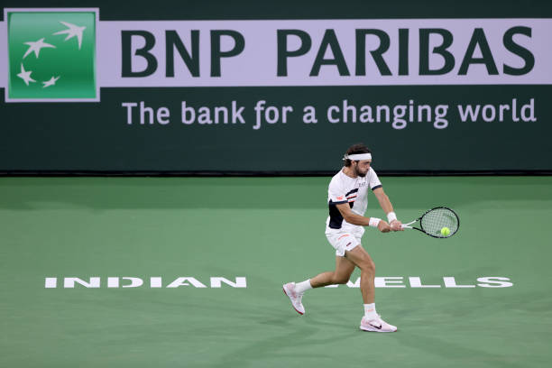 Nikoloz Bsilashvili of Georgia returns a shot to Cameron Norrie of Great Britain during the final of the BNP Paribas Open at the Indian Wells Tennis...